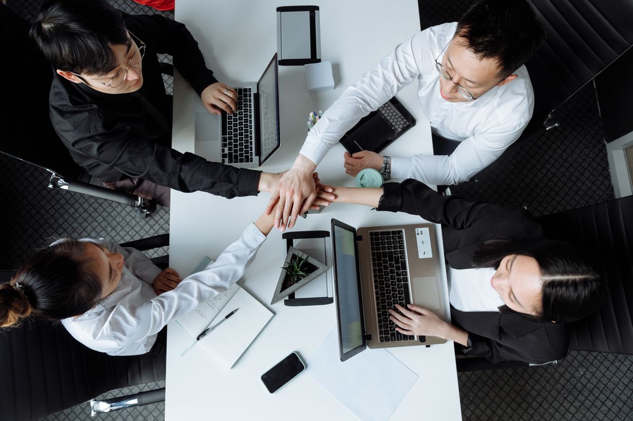 Top-down view of diverse professionals collaborating at a business meeting table.